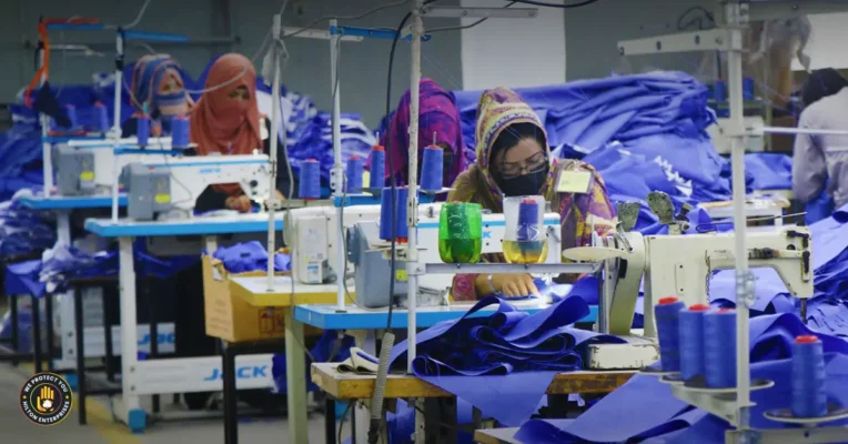 Professional seamstress working on made to order clothing production with industrial sewing machine