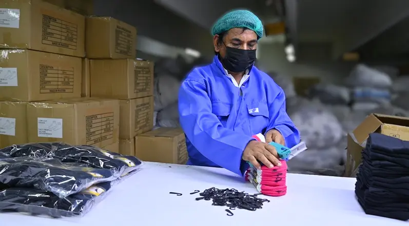 Neatly stacked bulk-packed white hospital grip socks in professional export packaging ready for wholesale shipment from Faisalabad Pakistan