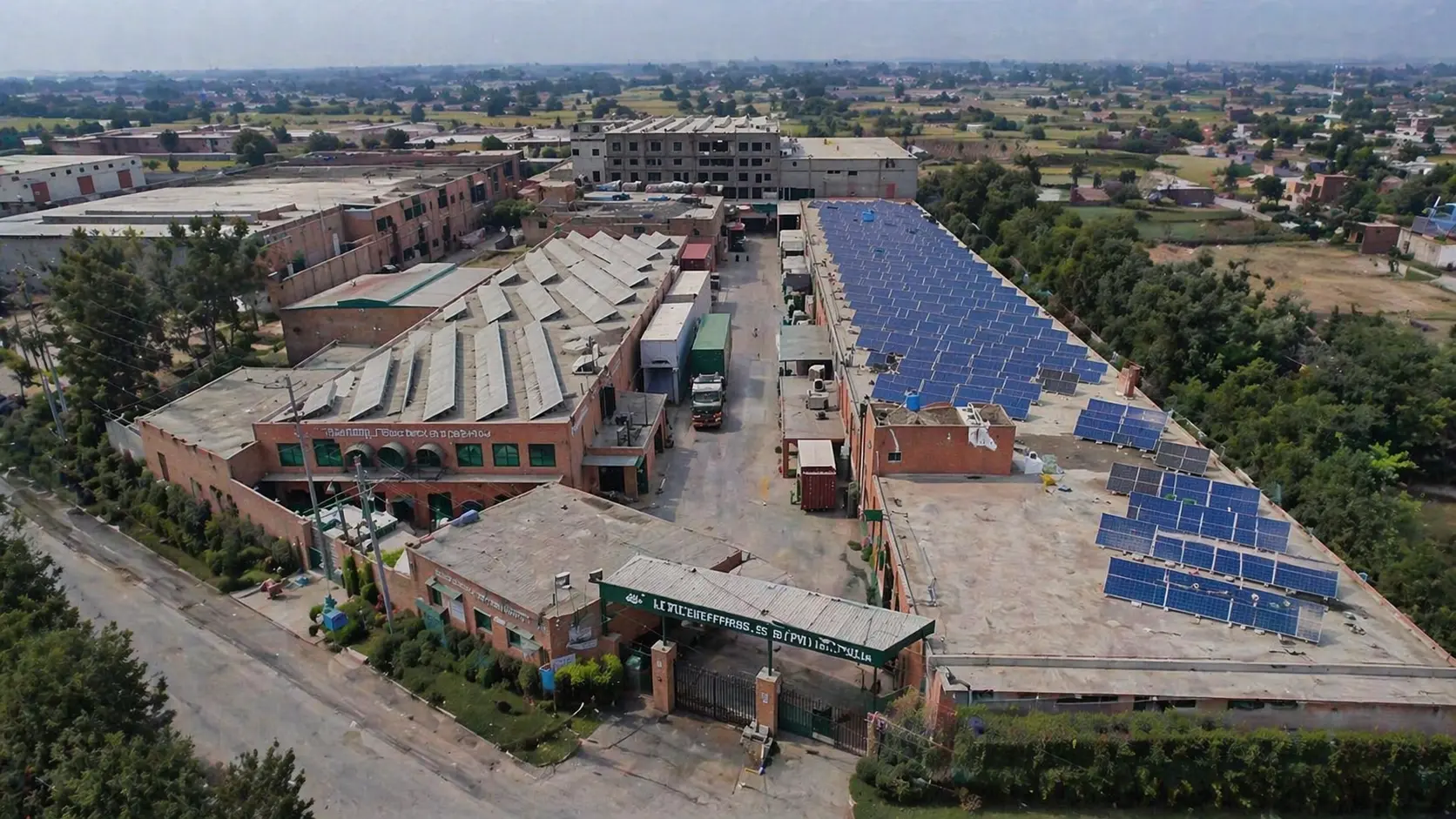 Wide view of a modern vertically integrated textile manufacturing facility in Faisalabad Pakistan producing hospital linen for export