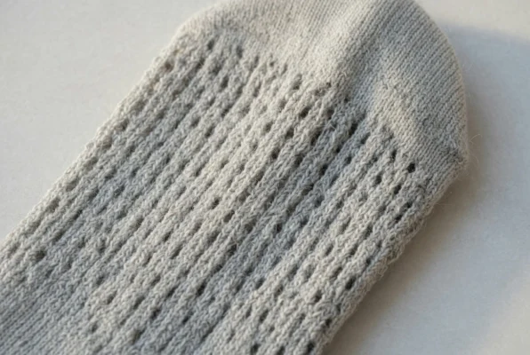 Close-up of merino wool compression sock fabric texture showing breathable knit