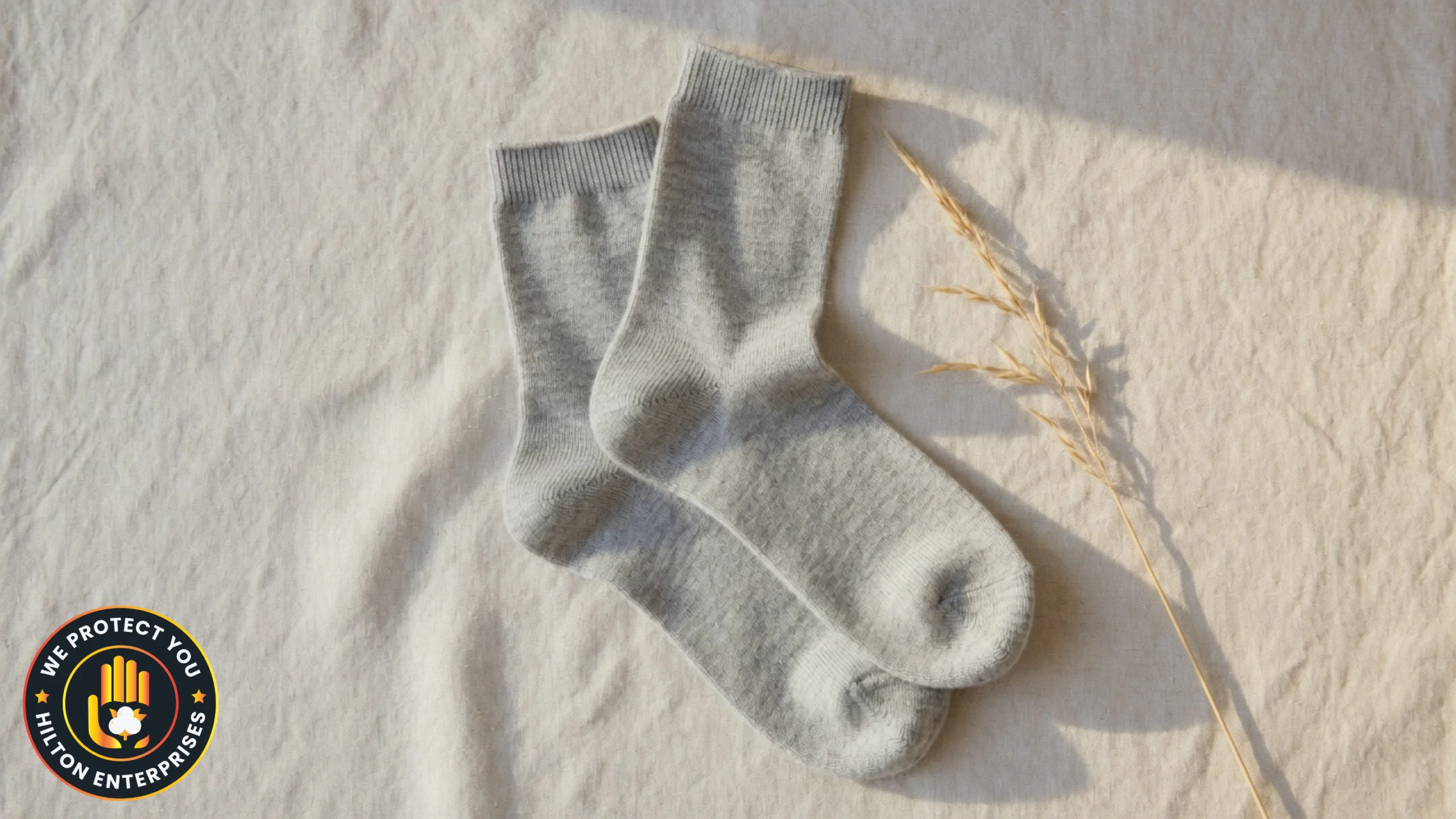 Close-up of lightweight merino wool crew socks laid flat on a natural linen surface in warm summer daylight showing fine open-knit fiber texture